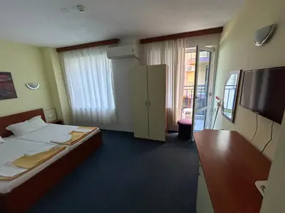 a hotel room with a bed and a television at Hotel North in Primorsko