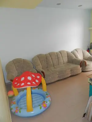 a living room with a table and a toy mushroom at Hotel North in Primorsko