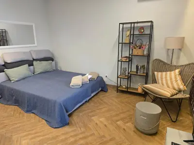 a bedroom with a blue bed and a chair at The Atelier in Burgas City