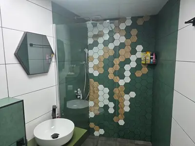 a bathroom with a shower with a toilet and a sink at The Atelier in Burgas City