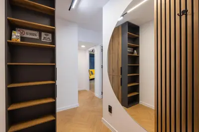 a hallway with wooden shelves in a house at TOPAZ Beachfront Apartment in Varna City