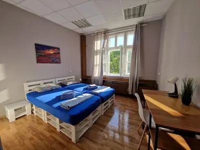 a bedroom with a bed and a table and a desk at Lambo's Corner Varna - Guest Rooms in Varna City