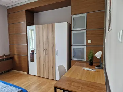 a room with a desk and a closet and a table at Lambo's Corner Varna - Guest Rooms in Varna City