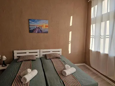 a bedroom with two beds with towels on them at Lambo's Corner Varna - Guest Rooms in Varna City