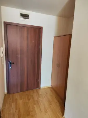 an empty room with a wooden door and wooden floors at Alexandr apartments Vigo Nesebar in Nesebar