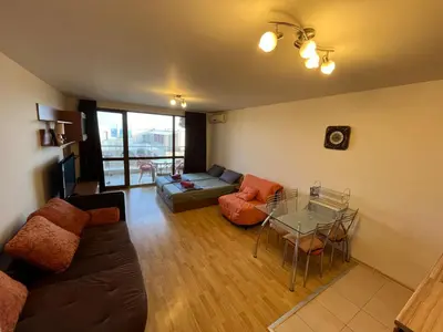 a living room with a couch and a table at Alexandr apartments Vigo Nesebar in Nesebar