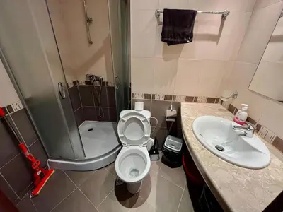 a bathroom with a toilet and a sink and a shower at Alexandr apartments Vigo Nesebar in Nesebar
