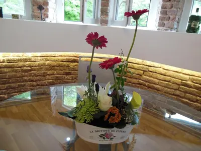 a vase filled with flowers on a table at Florence Studio in Varna City