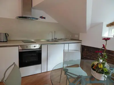 a kitchen with a glass table and a sink at Florence Studio in Varna City