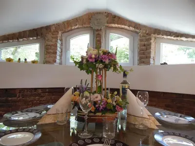 a dining room table with a vase of flowers on it at Florence Studio in Varna City