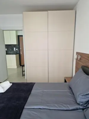 a bedroom with a bed and a large closet at Polarstar 2-Zimmer Appartements in Sveti Vlas