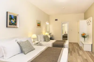 a bedroom with two beds and a living room at Hotel Venus in Sunny Beach