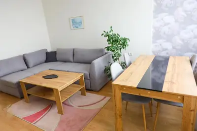 a living room with a couch and a table at Magnolia in Burgas City