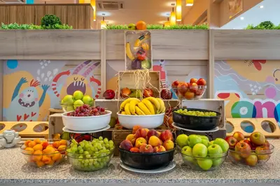a display of fruits and vegetables in bowls on a table at Asteria Family Sunny Beach - Ultra All Inclusive in Sunny Beach
