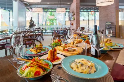 a wooden table with plates of food on it at Asteria Family Sunny Beach - Ultra All Inclusive in Sunny Beach
