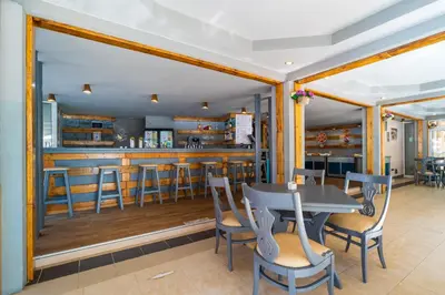 a dining room with a bar and a table and chairs at Asteria Family Sunny Beach - Ultra All Inclusive in Sunny Beach