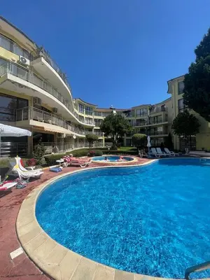 a large swimming pool in front of a building at Aurelia Residences in Ravda