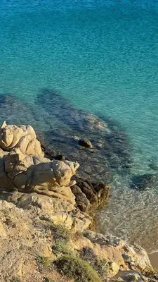 a group of rocks and the water on a beach at Aurelia Residences in Ravda