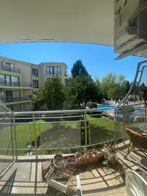 a balcony with a view of a yard and a building at Aurelia Residences in Ravda