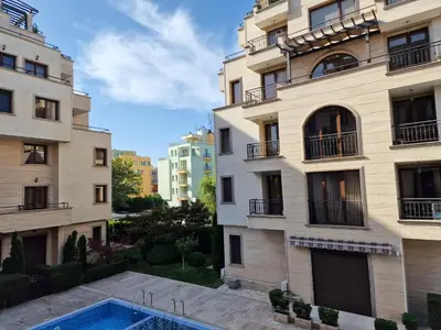 an apartment building with a swimming pool in front of it at Słoneczny Brzeg Studio Amara in Sunny Beach
