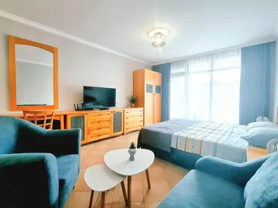 a bedroom with a bed and a tv and a couch at Marina Hills in Sozopol