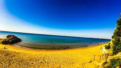 a beach with the ocean and people on it at William's apartments - sixth large apartment in Sveti Vlas