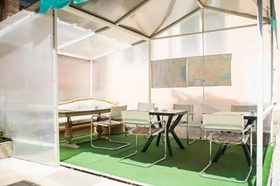 a room with a table and chairs in a tent at Стаи за гости in Varna City