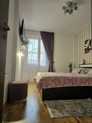 a bedroom with a bed and a window at Прекрасные апартаменты с видом на море в центре in Byala