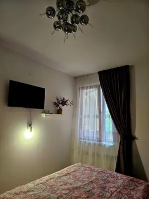 a bedroom with a bed and a window at Прекрасные апартаменты с видом на море в центре in Byala