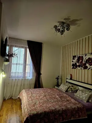 a bedroom with a bed and a window at Прекрасные апартаменты с видом на море в центре in Byala