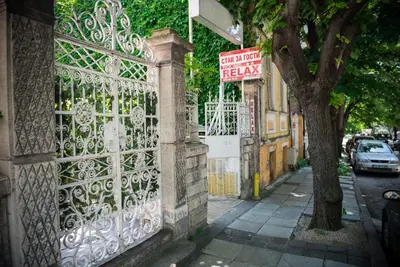 a gate to a building with a sign on it at Hotel Relax in Varna City