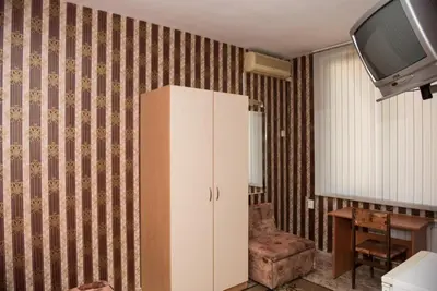 a white cabinet in a living room with a tv at Hotel Relax in Varna City