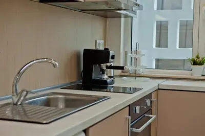 a kitchen with a sink and a coffee maker at Festival and Congress Centre Appartment Varna in Varna City