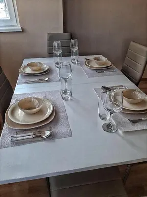 a table with plates and wine glasses on it at Sea Light in Burgas City