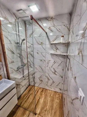 a bathroom with a shower and a sink at Sea Light in Burgas City