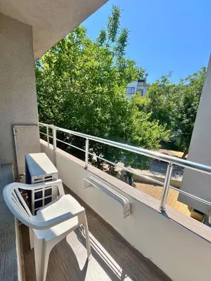 a white chair sitting on a balcony with a view at STELA in Nesebar