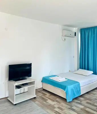 a hotel room with a bed and a tv at STELA in Nesebar