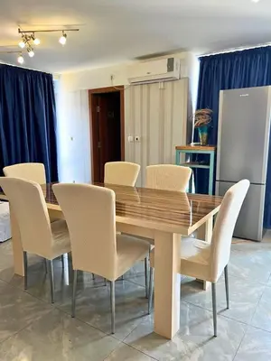 a dining room table with white chairs around it at STELA in Nesebar
