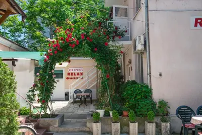 an arch with red flowers on a building at Стаи за гости in Varna City