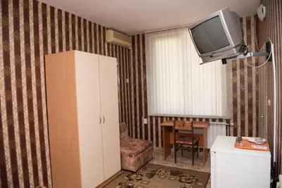 a living room with a tv on the wall at Стаи за гости in Varna City