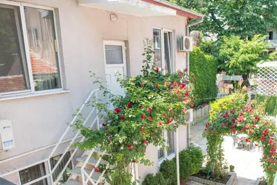 a house with flowers on the side of it at Стаи за гости in Varna City