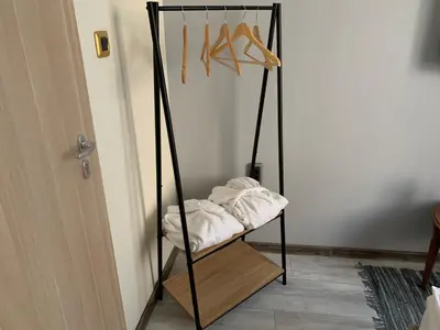 a room with a shelf with shoes on a wall at Guest Rooms Donovi in Varna City