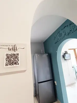 a kitchen with a refrigerator and a wall with graffiti at Sea Time Burgas1 in Burgas City