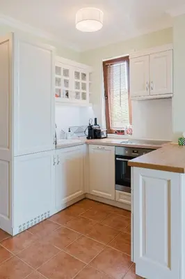 a kitchen with white cabinets and a counter top at Sozopol Созопол- SOZOPOLIS -MORE SUN 2А- in Sozopol