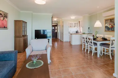 a living room and kitchen with a couch and a table at Sozopol Созопол- SOZOPOLIS -MORE SUN 2А- in Sozopol