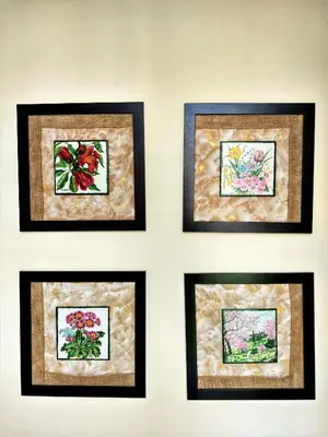 a wall with four framed pictures of flowers at Elizabeth Dy Boutique Hotel in Nesebar