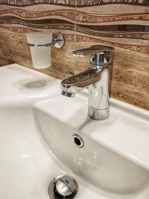 a bathroom sink with a chrome faucet on it at Elizabeth Dy Boutique Hotel in Nesebar