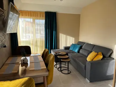 a living room with a couch and a table at Varna downtown apartment in Varna City