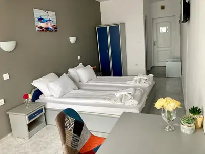 a small room with a bed and a table at Plovdiv Hotel in Primorsko