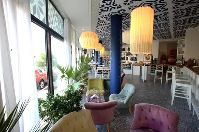 a lobby with chairs and tables in a restaurant at Villa Livia Boutique Apartments in Ravda